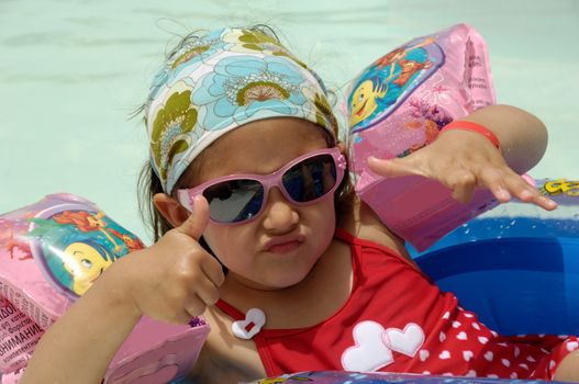 cool child is relaxing in pool.