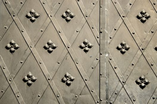 background of metal blacksmith handmade decorative doors . ancient architecture of castle gate backdrop.