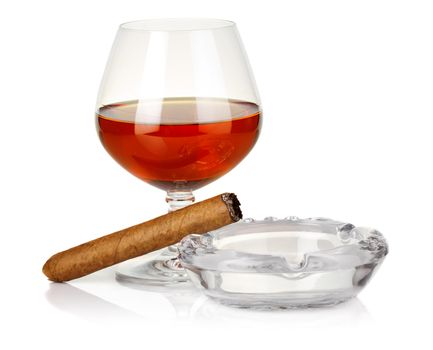 Cognac in glass with cigar and ashtray isolated on white background