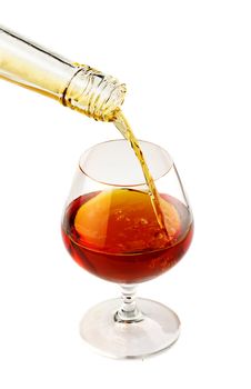 Filling a glass of brandy isolated on white background