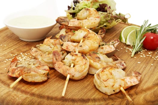grilled shrimp with a salad on a wooden plate