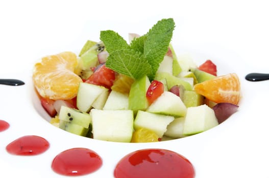 fruit salad on a white plate in a restaurant