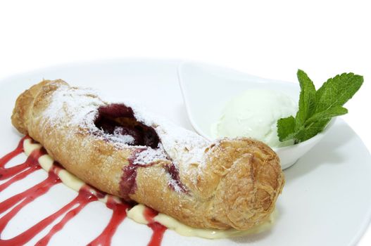 strudel decorated with mint jelly on white background