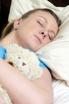 Young girl fell asleep with teddy bear