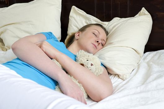 Young girl fell asleep with teddy bear