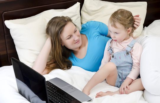 Happy family watching a cartoon on the laptop