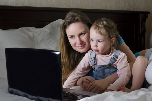 Happy family watching a cartoon on the laptop