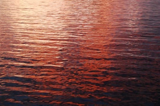 deep color sunset reflections on beach water