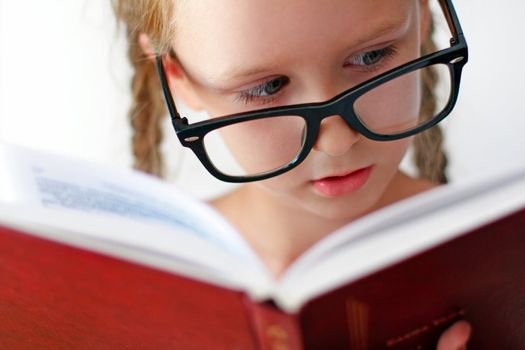 Little schoolgirl with books. Studio shot