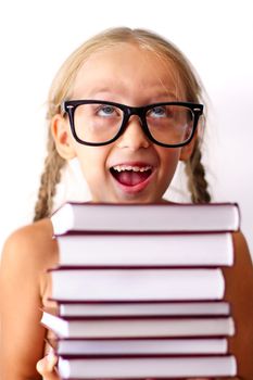 Little schoolgirl with books. Studio shot