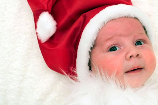 Baby dressed as Santa Claus