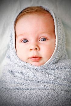 portrait of a smiling baby in a  fabric