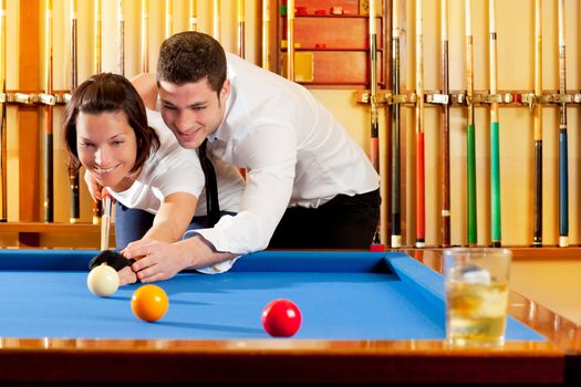 couple playing billiard expertise teacher and beautiful girl