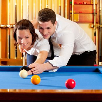 couple playing billiard expertise teacher and beautiful girl