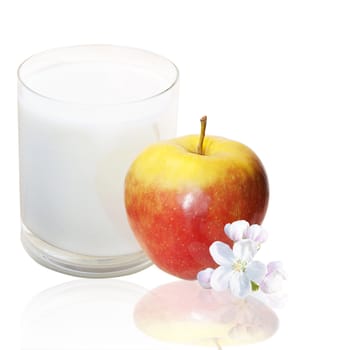 The red apple glass of fresh milk over white background