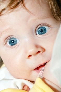 Closeup face of a beautiful baby with blue eyes.