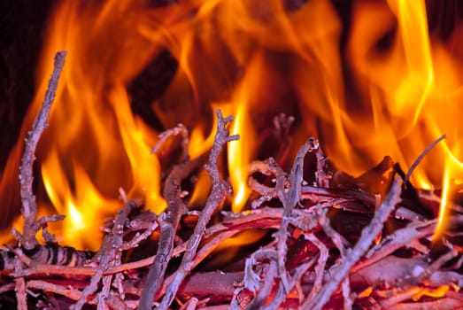 Burning wood in the fireplace and the flames.