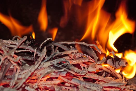 Burning wood in the fireplace and the flames.