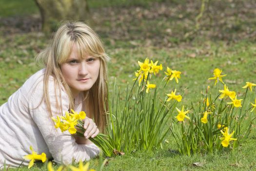 beautiful young woman with flowers on a warm spring day