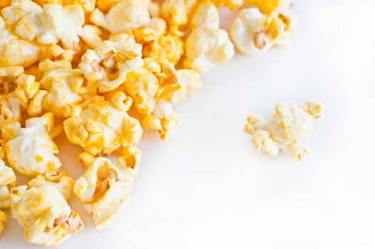 Salted popcorn grains on the white background