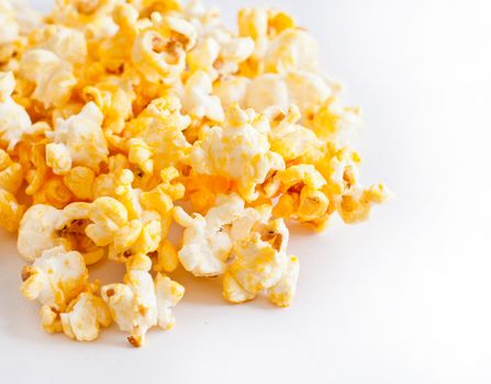Salted popcorn grains on the white background