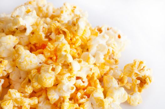 Salted popcorn grains on the white background