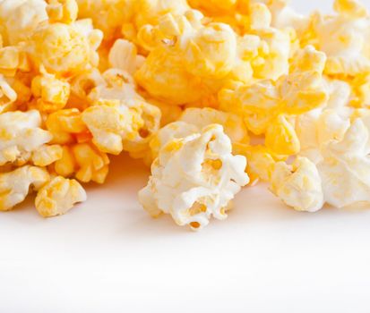 Salted popcorn grains on the white background