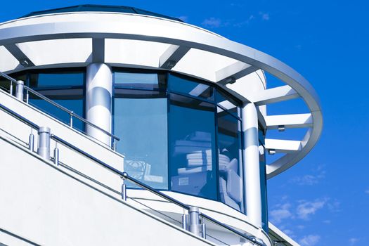 facade of modern building in blue and white tones on a background bright sky