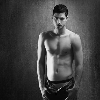 Black and white sexy young denim shirtless man on retro grunge background