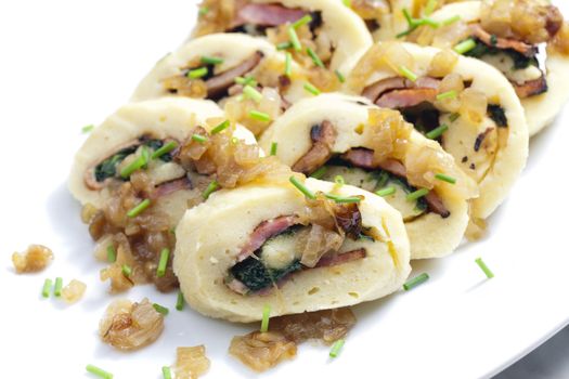 roll from potato dough filled with spinach and bacon
