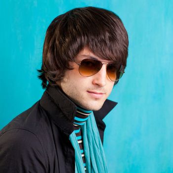 british indie pop rock look retro hip young man with sunglasses on blue