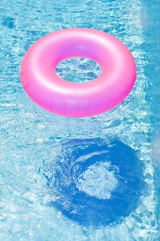 pink rubber ring in swimming pool