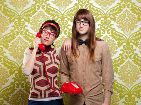 funny nerd humor couple talking retro vintage red telephone on wallpaper