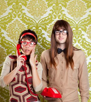 funny nerd humor couple talking retro vintage red telephone on wallpaper