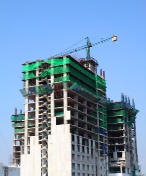 Under construction building with blue sky in bangkok