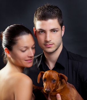 Couple in love with brown little pet puppy dog mini pinscher