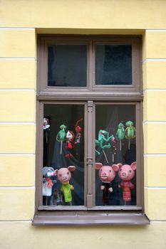 Toys in a house window, behind glass