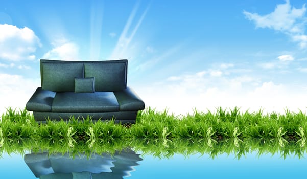 Sofa on the grass with the bright sky