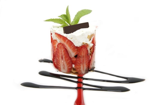 Strawberry dessert decorated with mint on a white background