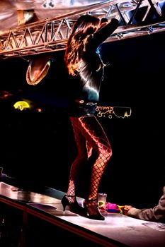 go-go girl dancing on a bar of a public festival