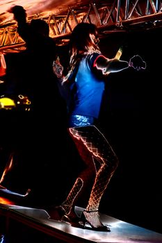 go-go girl dancing on a bar of a public festival