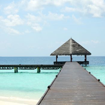 resort maldivian houses in blue sea