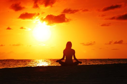 sunset yoga woman on sea coast