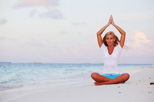 yoga woman on sea coast