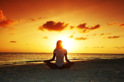 sunset yoga woman on sea coast