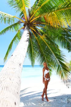 woman under palm sea on backgroud