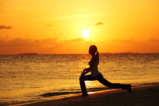 sunset yoga woman on sea coast