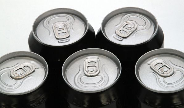 Tops of drink cans against a plain white background.