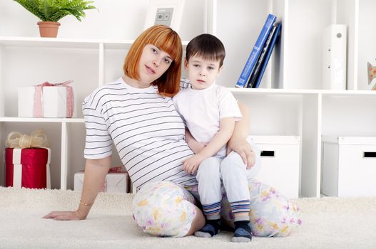 portrait of a pregnant woman and her son, at home