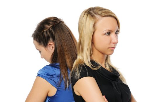 Two young attractive women standing back to back. Isolated on white.